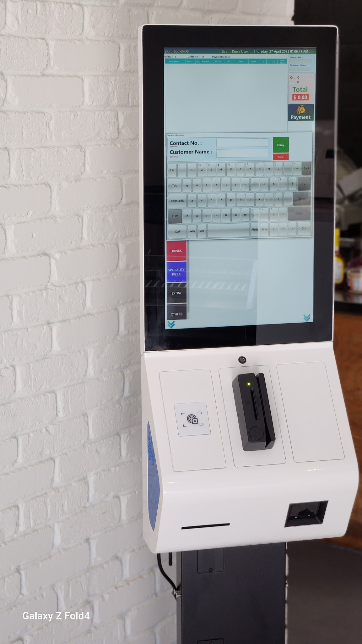 Floor-standing self-service kiosk installed in a store
